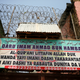 Layers of security barbed wires are seen on top of a banner on an Islamic school where hundreds of men and boys were rescued from captivity by police in Kaduna, Nigeria Sept.28, 2019.